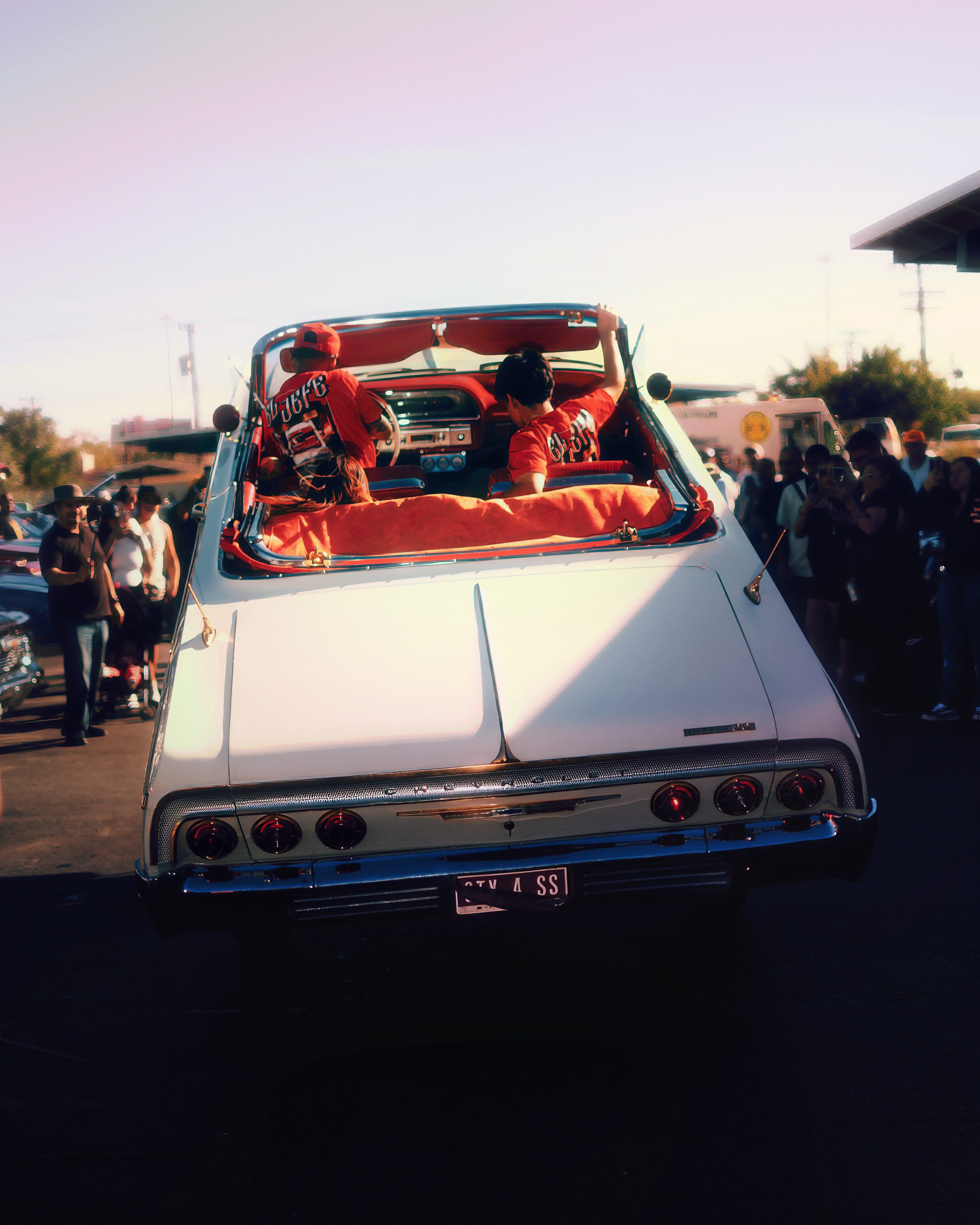 White Impala at car show with red interior