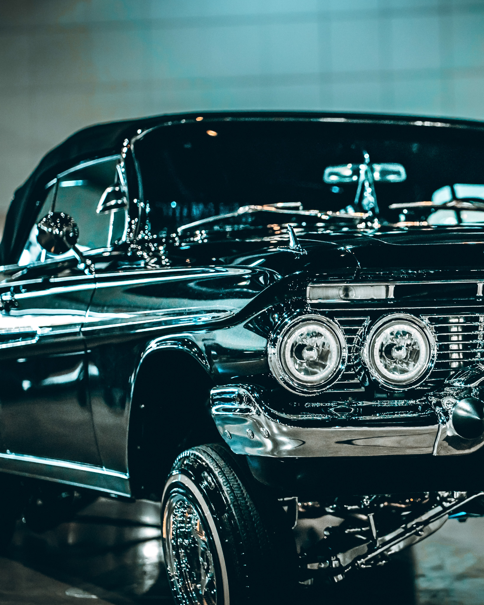 Moody black classic lowrider car with dramatic lighting and atmosphere